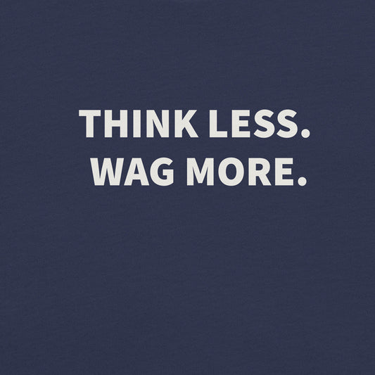 White text on a dark blue background reads, "THINK LESS. WAG MORE."—the perfect mantra featured on our Think Less. Wag More. Dog Lover Tee by THiNK LiKE A DOG®.