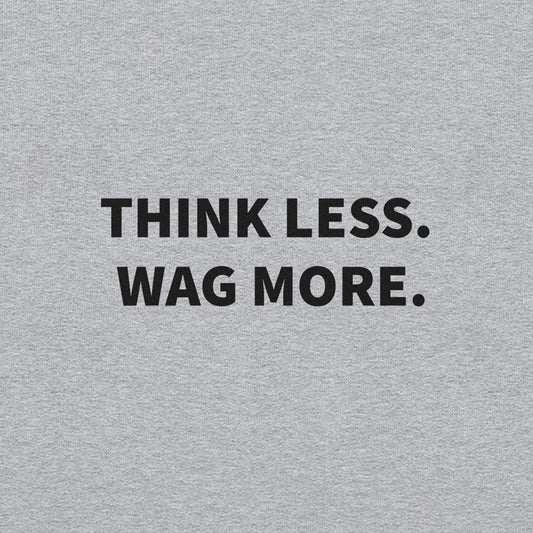 The "Think Less. Wag More." Dog Lover Crewneck Sweatshirt by THiNK LiKE A DOG® features a gray background and bold black text—perfect comfort wear for stress relief and ideal for every true dog lover.