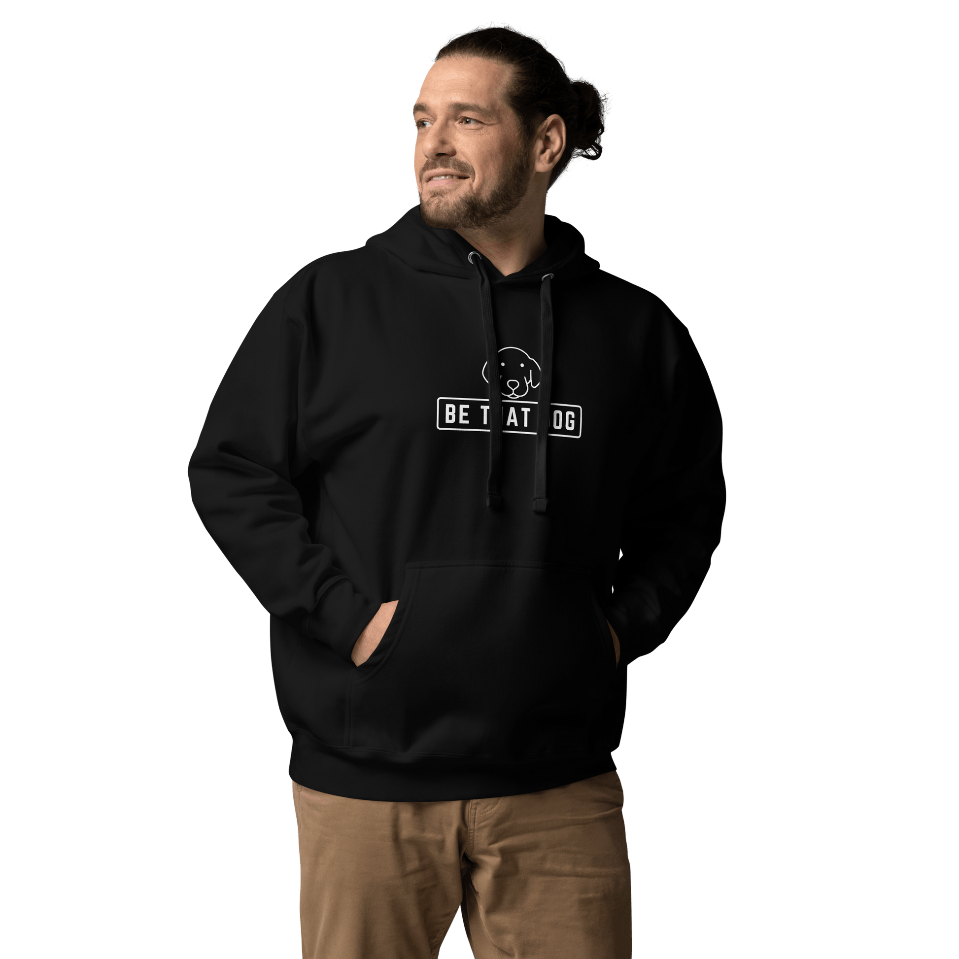 A man sports the ultra-soft Be THAT Dog Minimalist Hoodie by THiNK LiKE A DOG®, featuring "Be That Dog" text and a simple dog design. He looks off to the side with hands in pockets, embodying a true essential for dog lovers.