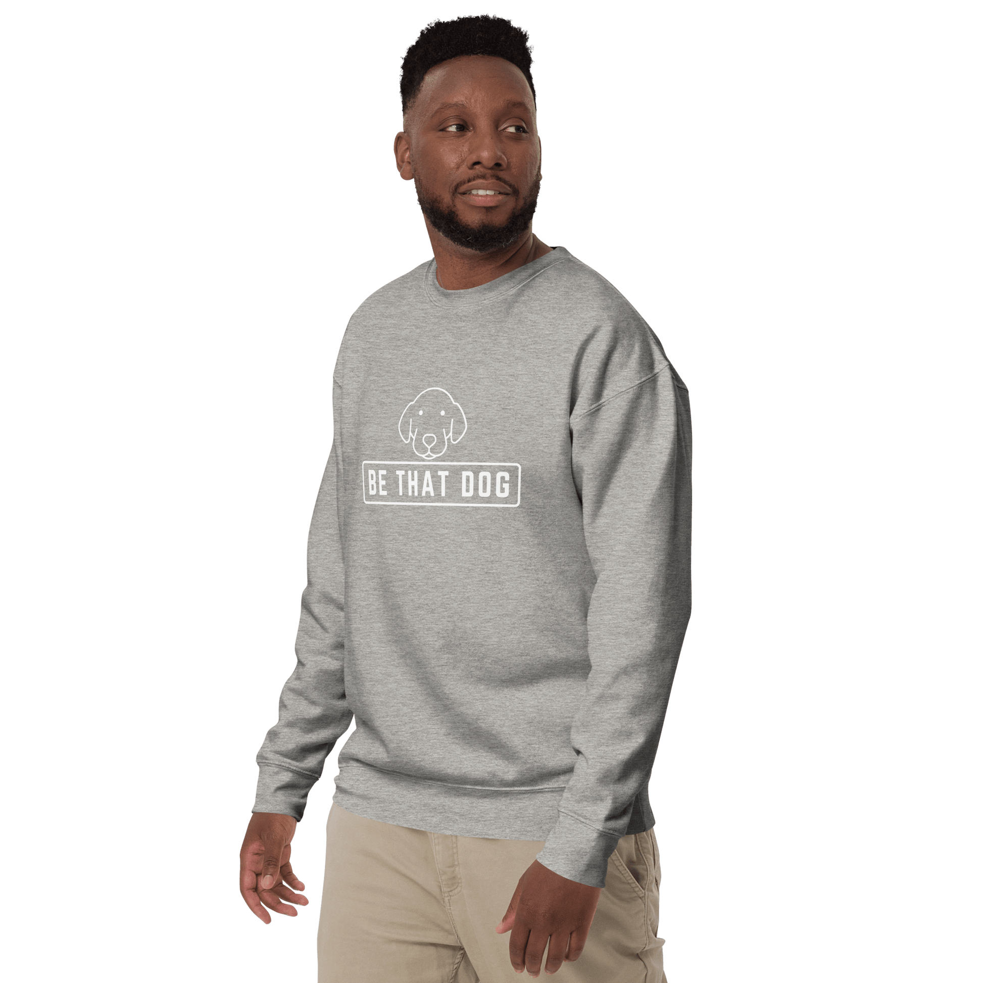 A man wears the THiNK LiKE A DOG® Be THAT Dog Minimalist Sweatshirt, featuring "BE THAT DOG" and a simple dog illustration—a cozy and confident streetwear essential for dog lovers.