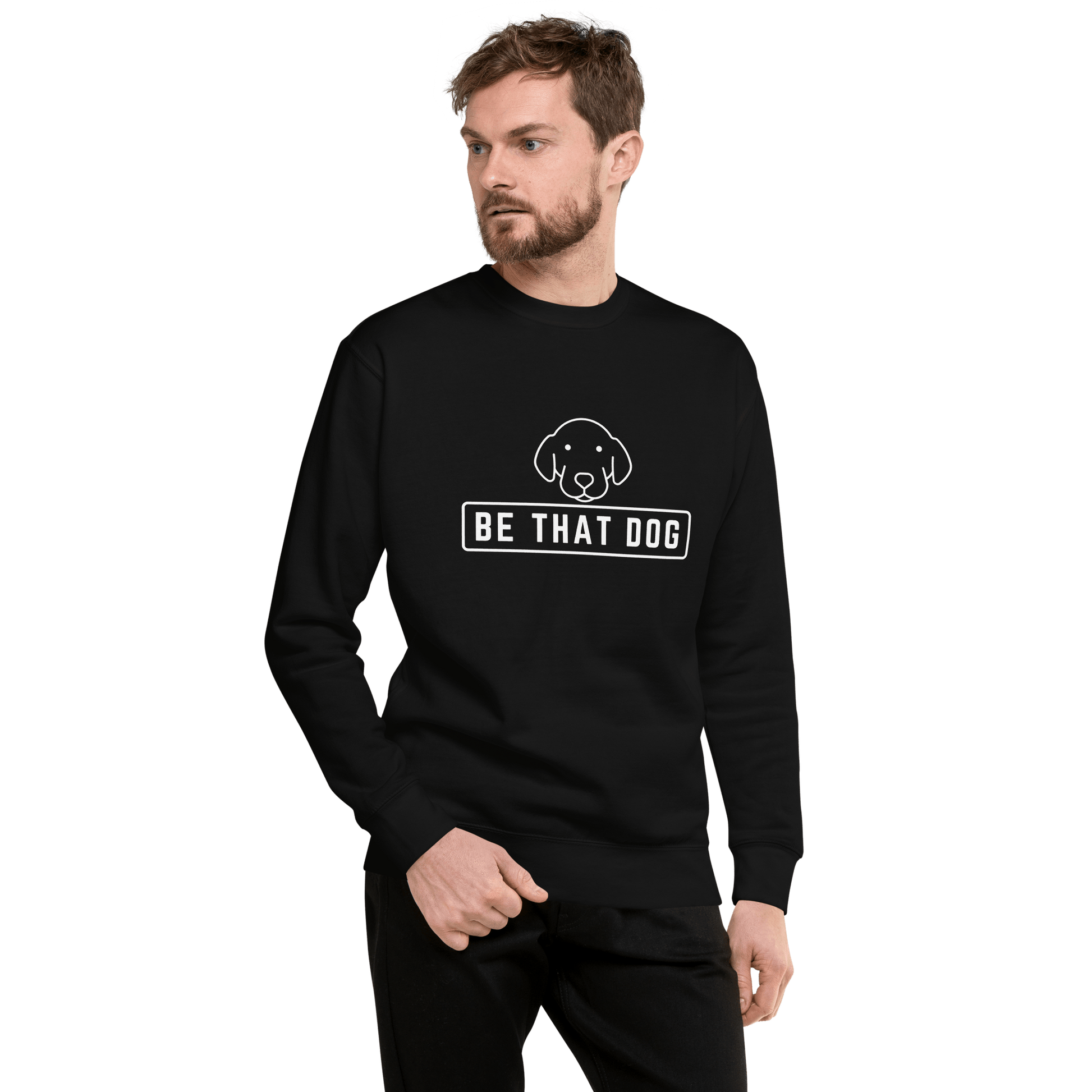 A man wears the Be THAT Dog Minimalist Sweatshirt by THiNK LiKE A DOG®, featuring a smiling dog face and the phrase "BE THAT DOG," perfect for modern streetwear in a dog lover's essential wardrobe.
