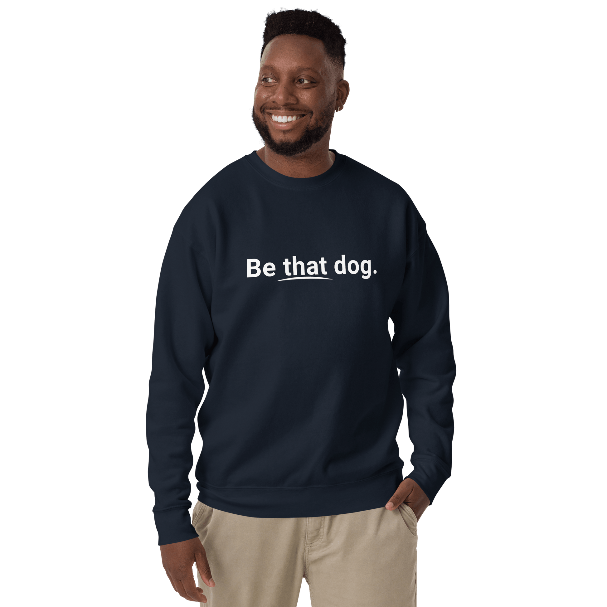 A man wearing the "Be That Dog Simple Statement Sweatshirt" by THiNK LiKE A DOG® smiles casually, embodying everyday wear with this minimalist navy unisex sweater for dog lovers.