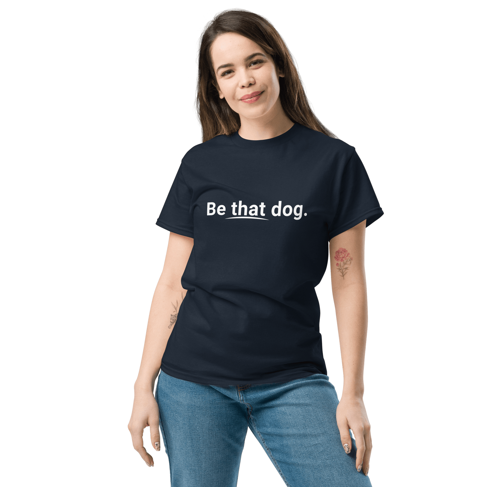A person wears a THiNK LiKE A DOG® ultra-soft cotton black tee, featuring "Be that dog." on it, standing against a white background. This minimalist shirt is perfect as a dog lover gift for any occasion.