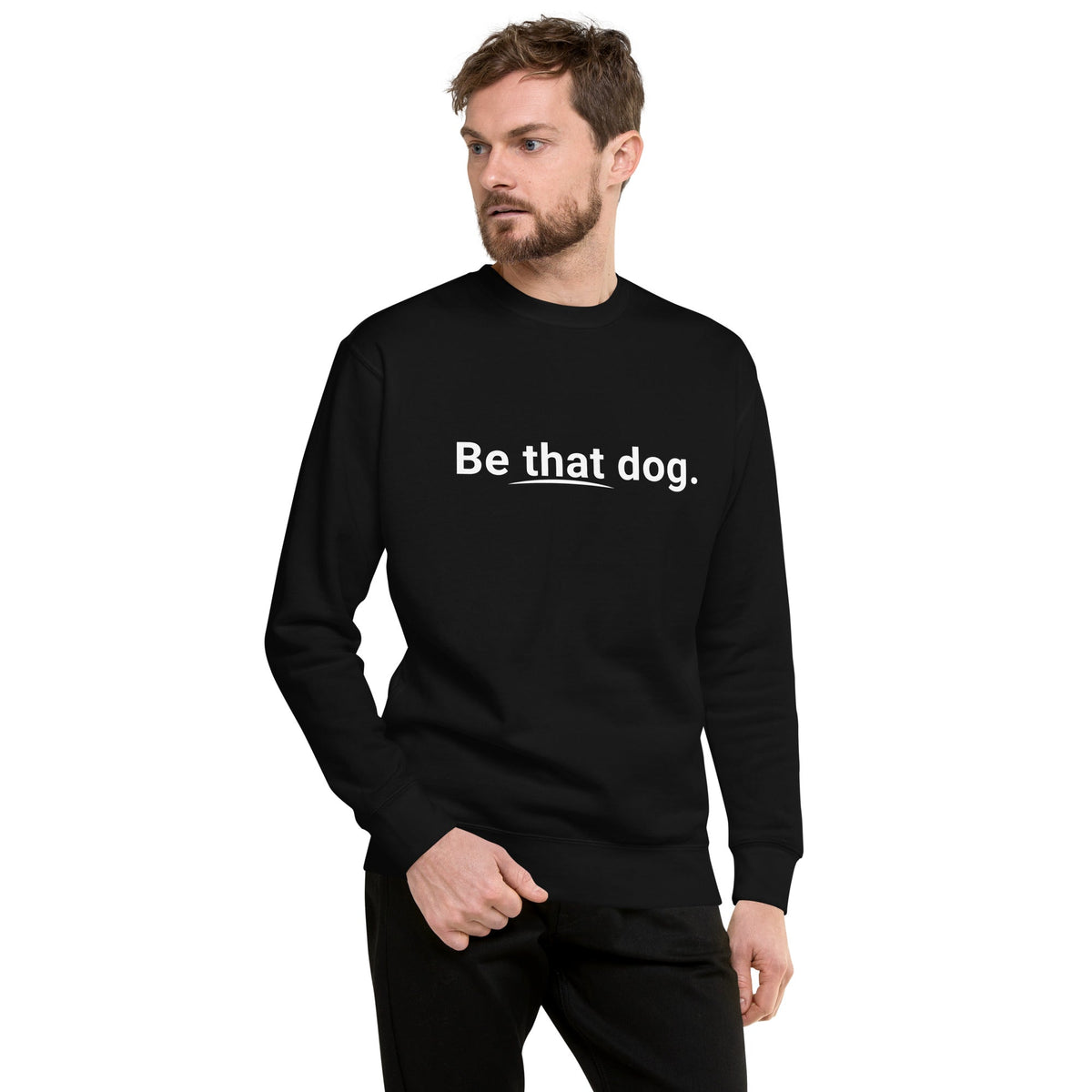 A man wears the Be That Dog Sweatshirt – Simple Statement, featuring "Be that dog." text, against a…