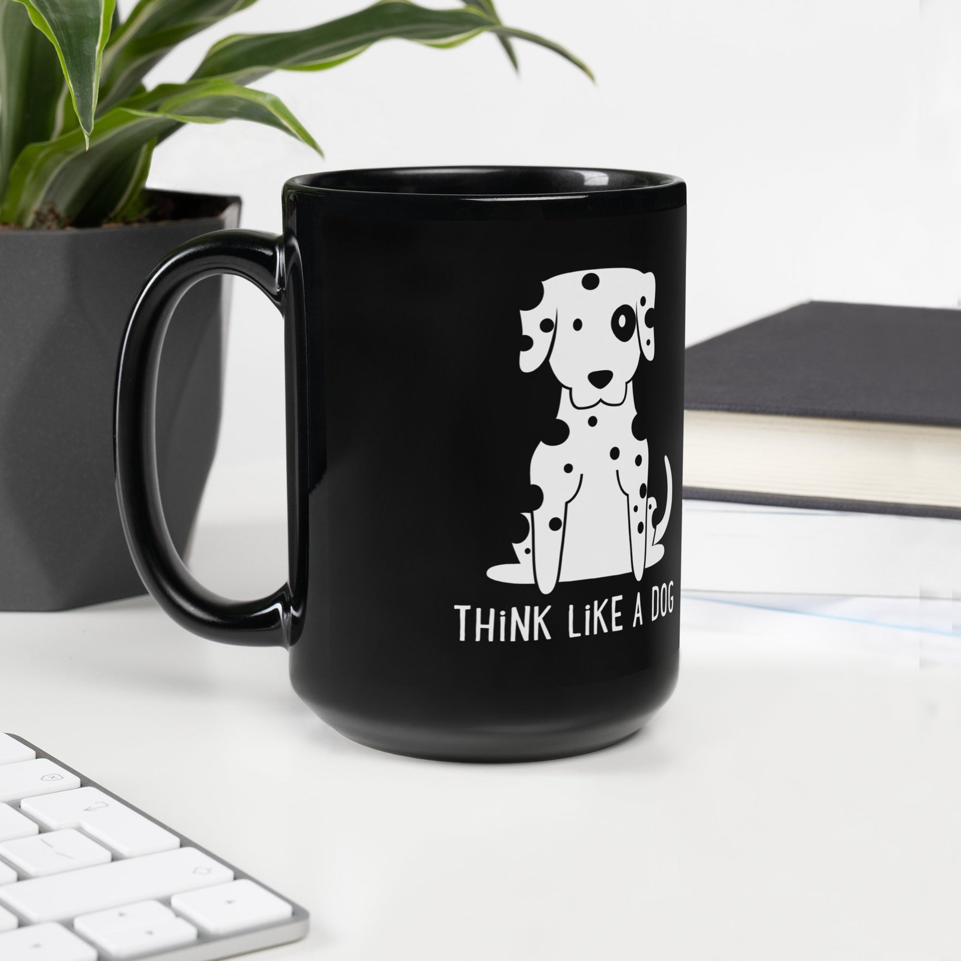 The Funny Dog Mug – Dalmatian Design for Pet Lovers by THiNK LiKE A DOG® features a cartoon pup and playful text, making it an ideal dog lover gift or funny desk mug. Shown on a desk near a plant, books, and keyboard.