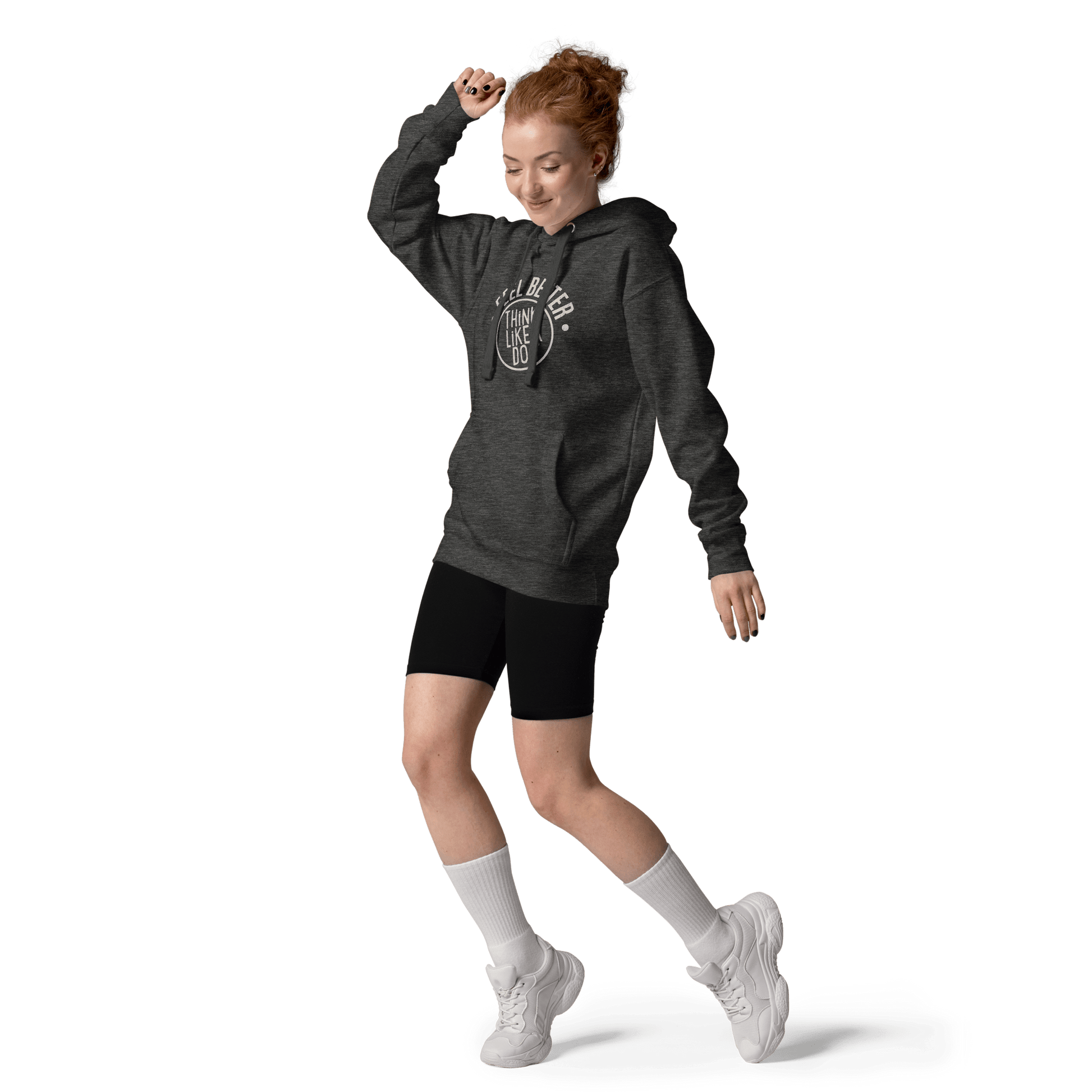 A curly-haired person energetically jumps against a black background wearing THiNK LiKE A DOG® Feel Better Dog Lover Hoodie, paired with black shorts, long white socks, and white sneakers.