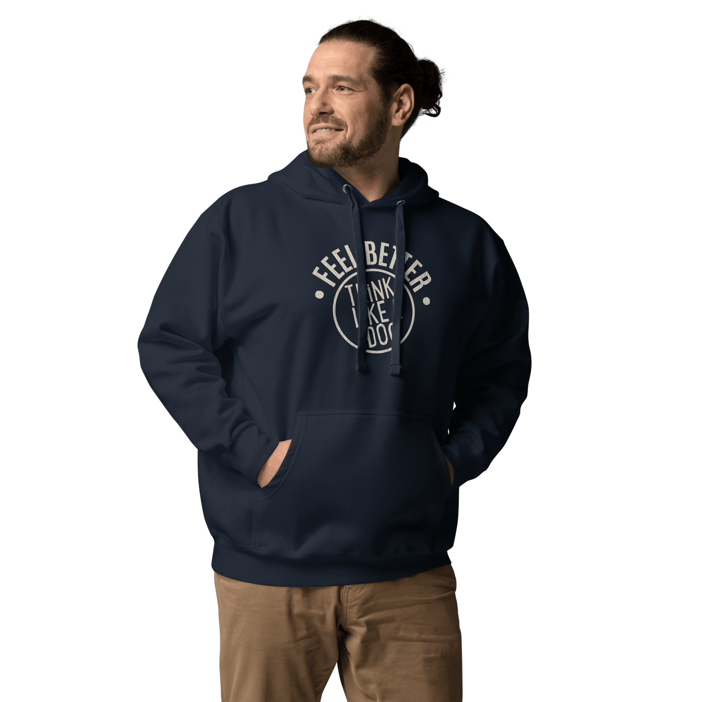 A man smiles in a navy "FEEL BETTER" hoodie featuring a circular design, paired with beige pants against a black background. Perfect gift from THiNK LiKE A DOG® for pet owners or dog moms.