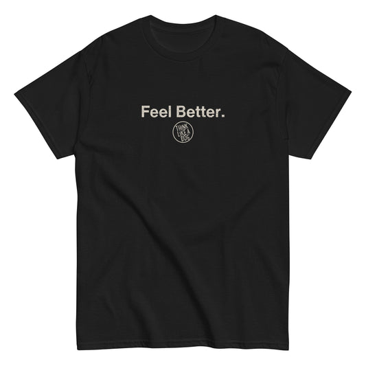 THiNK LiKE A DOG® offers a unisex black T-shirt with "Feel Better." in white above a circular "Hvnly Dog" logo. It's perfect for dog lovers who cherish pet companionship—a comforting gift for pet owners.