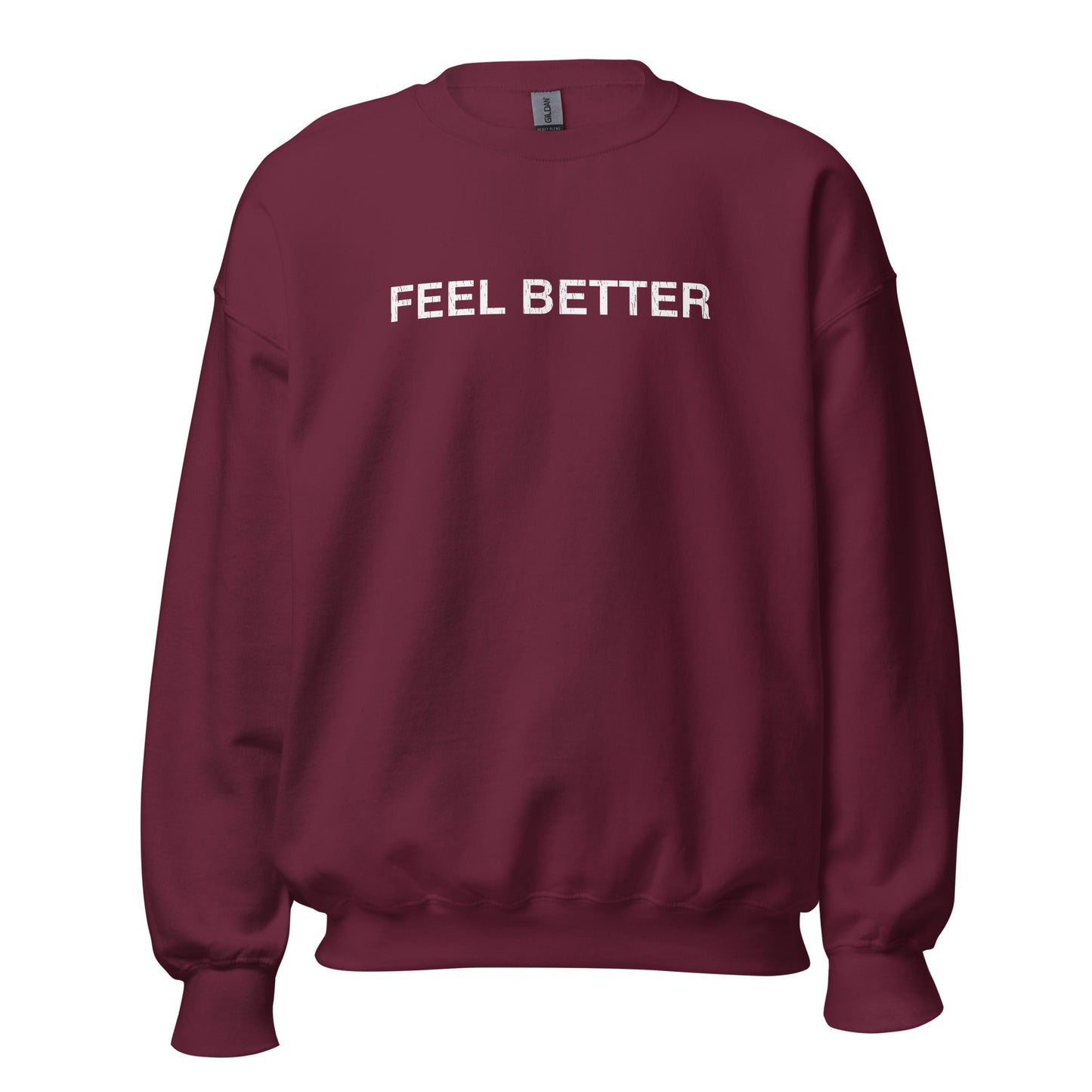 The "Feel Better | Inspirational Comfort Sweatshirt" by THiNK LiKE A DOG® is a maroon unisex crewneck with "FEEL BETTER" in bold white on the front. It's the perfect dog-inspired self-care gift for anyone needing a positivity boost.