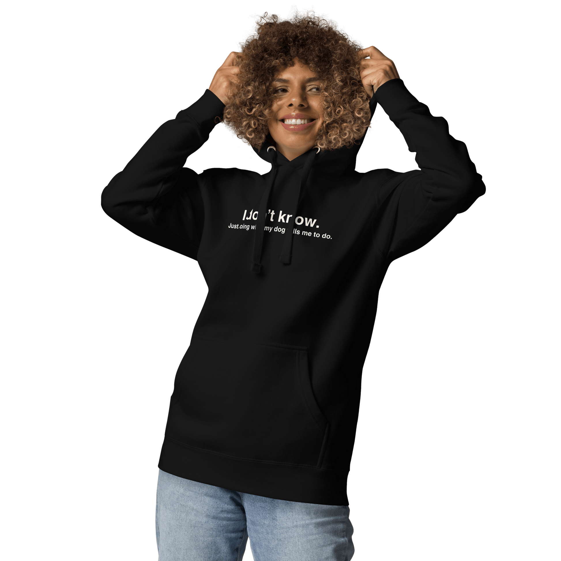 Smiling person wears the Funny Dog Hoodie – Just Doing What My Dog Tells Me by THiNK LiKE A DOG®, featuring white text and a transparent background. Great unisex gift for dog lovers.