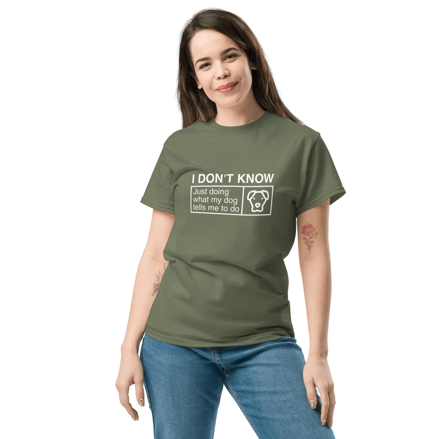 A woman stands with one hand in her pocket, wearing the THiNK LiKE A DOG® Funny Dog Shirt—Dog Icon “Just Doing What My Dog Tells Me”—a perfect gift for dog lovers.