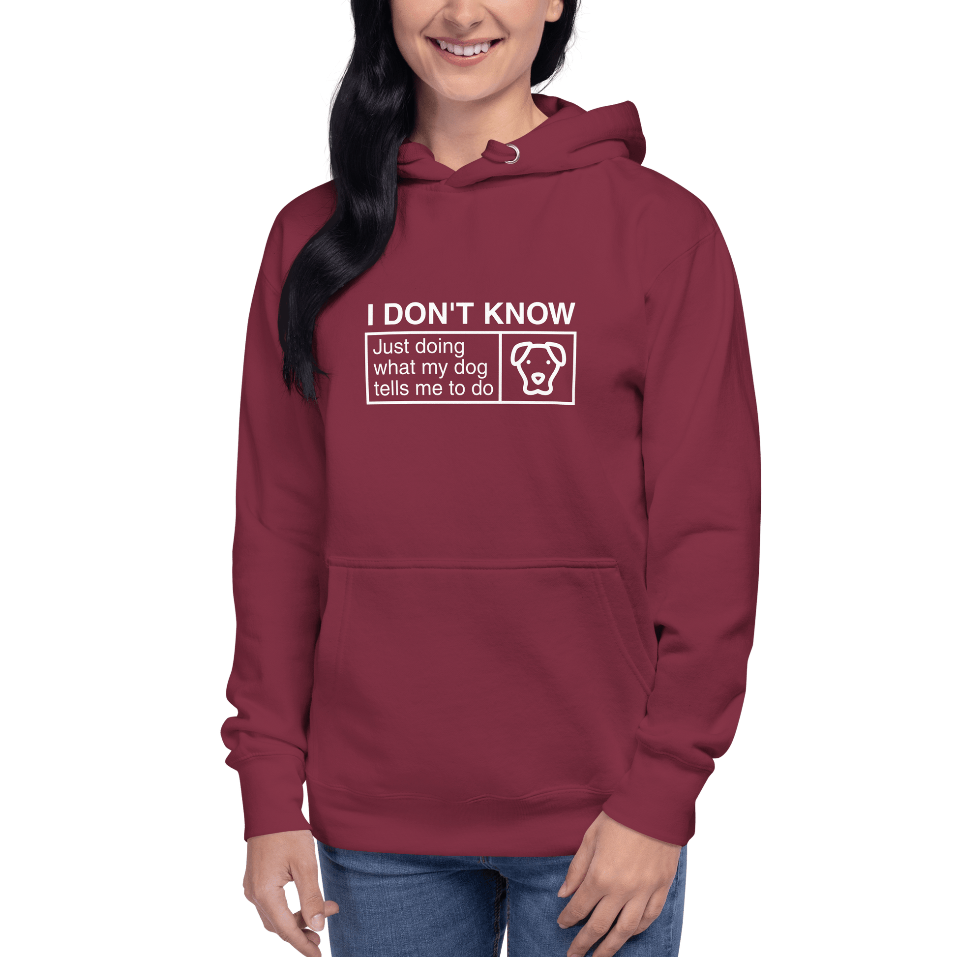Sporting THiNK LiKE A DOG®'s ultra-soft maroon hoodie, the wearer displays a quirky text: "I Don’t Know, Just Doing What My Dog Tells Me," featuring a playful dog illustration—ideal for dog lovers.