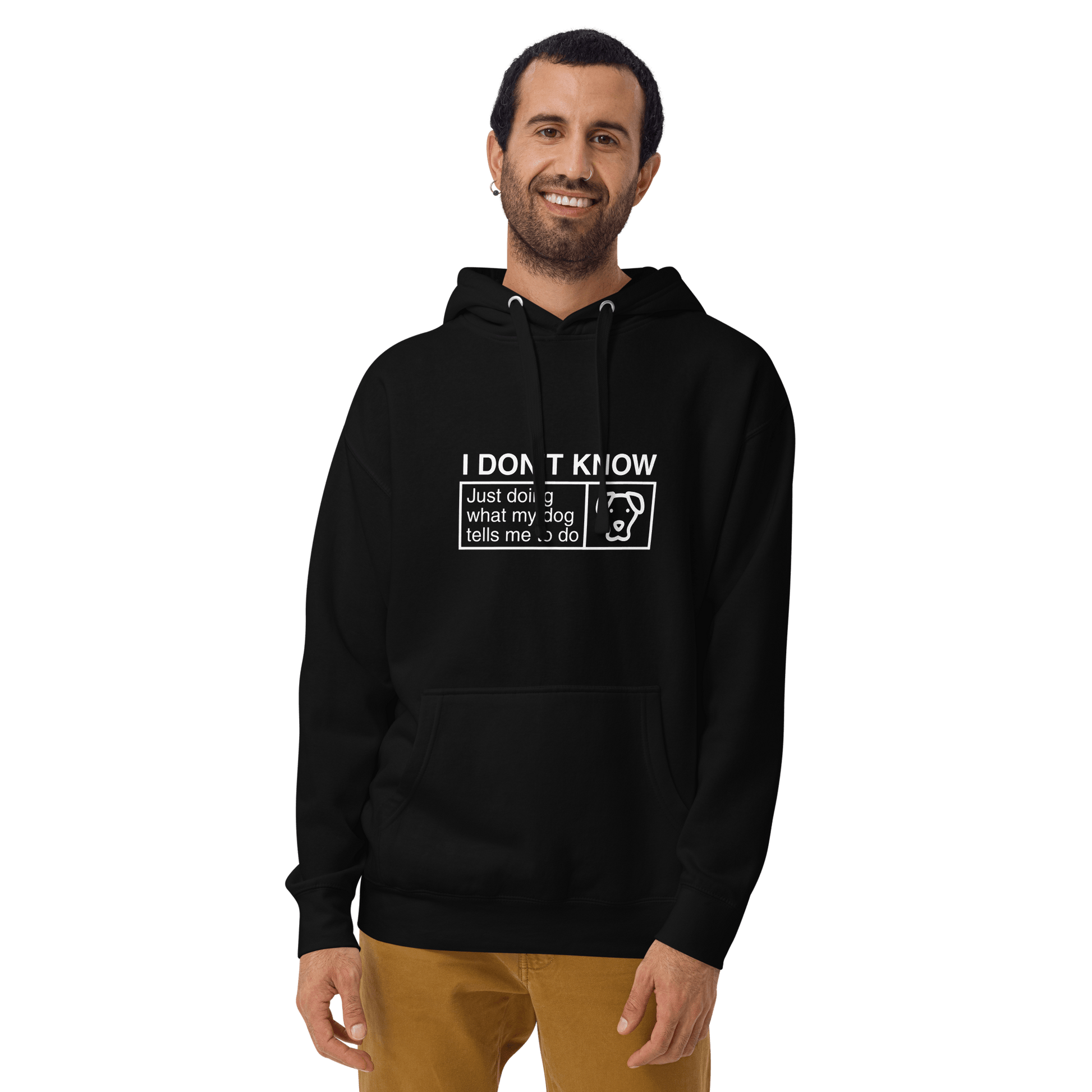 A person wearing the THiNK LiKE A DOG® Humorous Dog Hoodie, featuring the text "I Don’t Know, Just Doing What My Dog Tells Me," smiles while standing against a plain background.