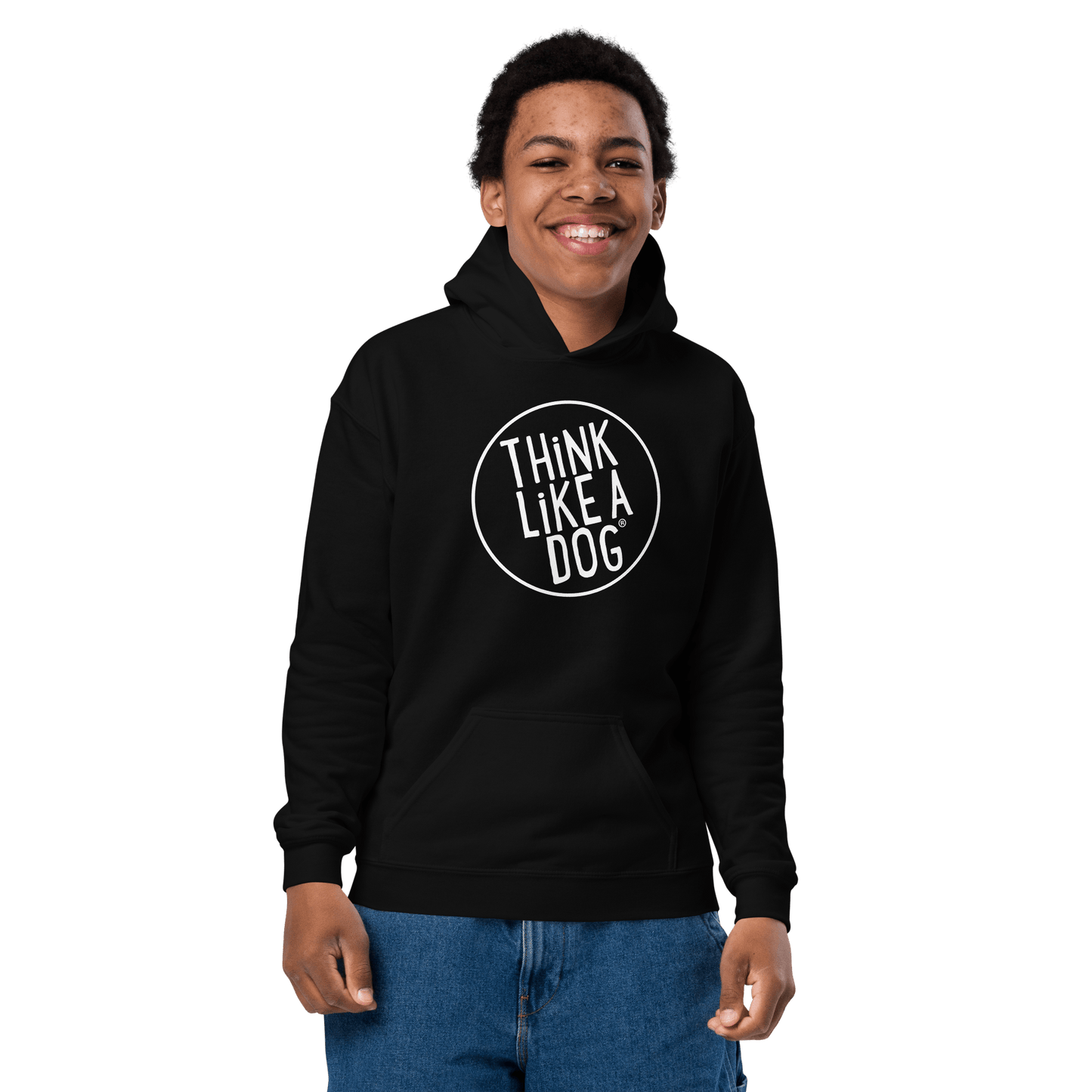 A child in a Kids Heavy Blend Hoodie with the THiNK LiKE A DOG® white logo smiles against a black backdrop, embodying true Dog-Lover Style.