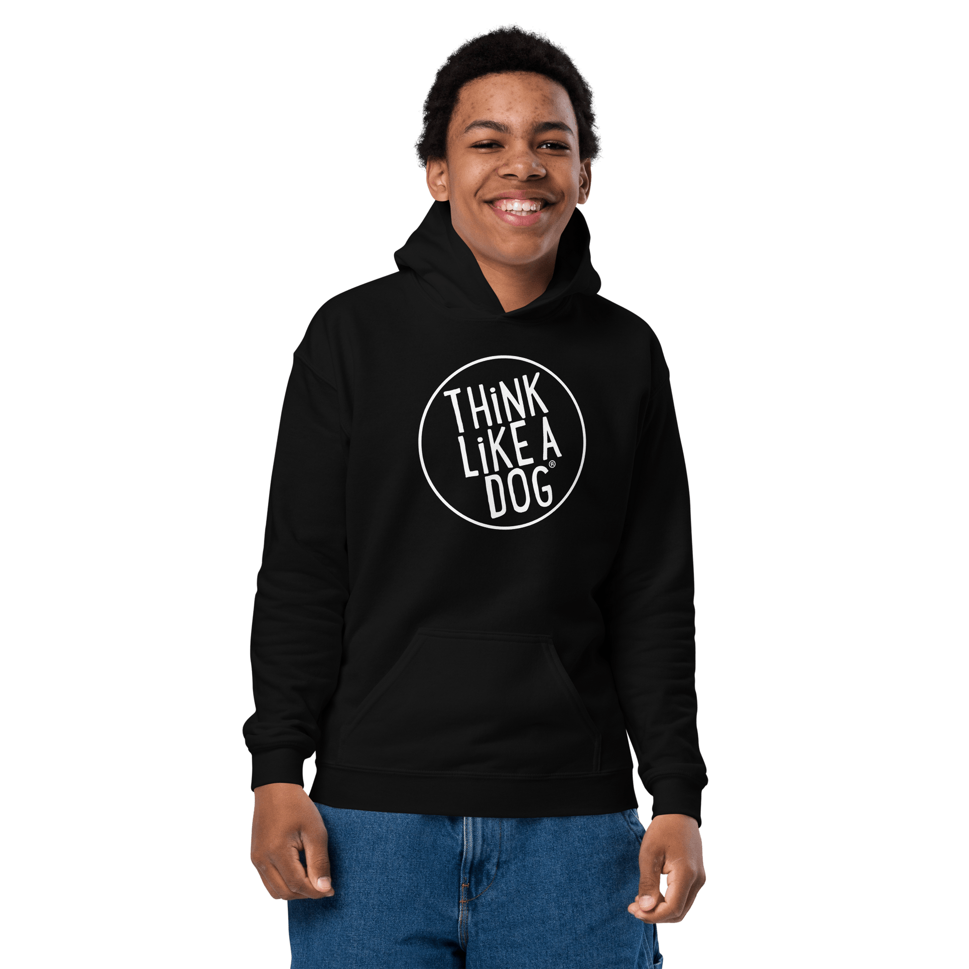 A child in a Kids Heavy Blend Hoodie with the THiNK LiKE A DOG® white logo smiles against a black backdrop, embodying true Dog-Lover Style.