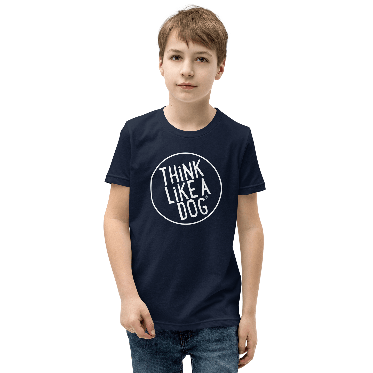 A young dog-loving child proudly wears a navy Kids' Short Sleeve T-Shirt by THiNK LiKE A DOG®, showcasing the "Think Like a Dog® White Logo.