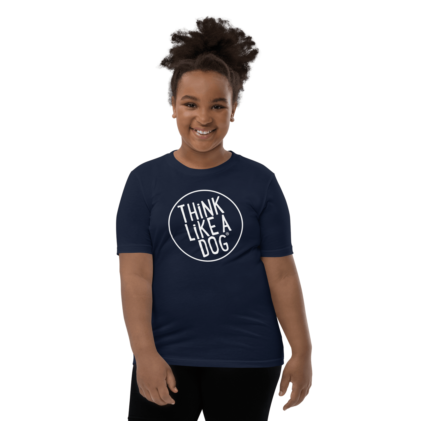 A smiling child wears a navy Kids' Short Sleeve T-Shirt from THiNK LiKE A DOG® with a white logo, perfect for dog-loving kids.