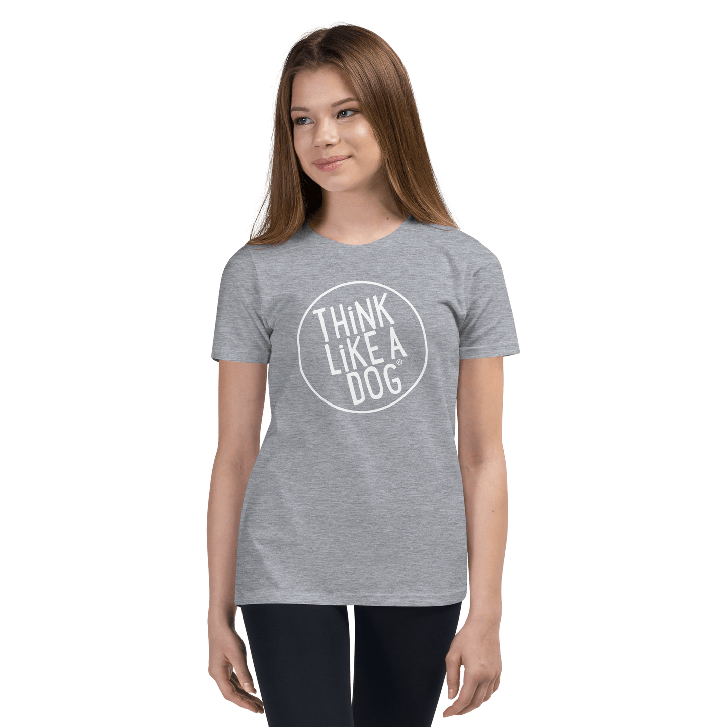 Against a plain background, a person wears the Kids' Short Sleeve T-Shirt with the THiNK LiKE A DOG® white logo, paired with black pants—a perfect look for dog-loving kids.
