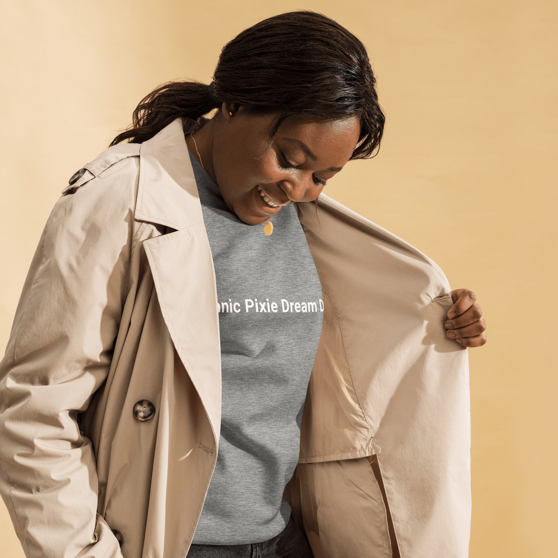 Someone in a beige trench coat reveals the Manic Pixie Dream Dog Navy Sweatshirt by THiNK LiKE A DOG®, showcasing its minimalist and stylish design.