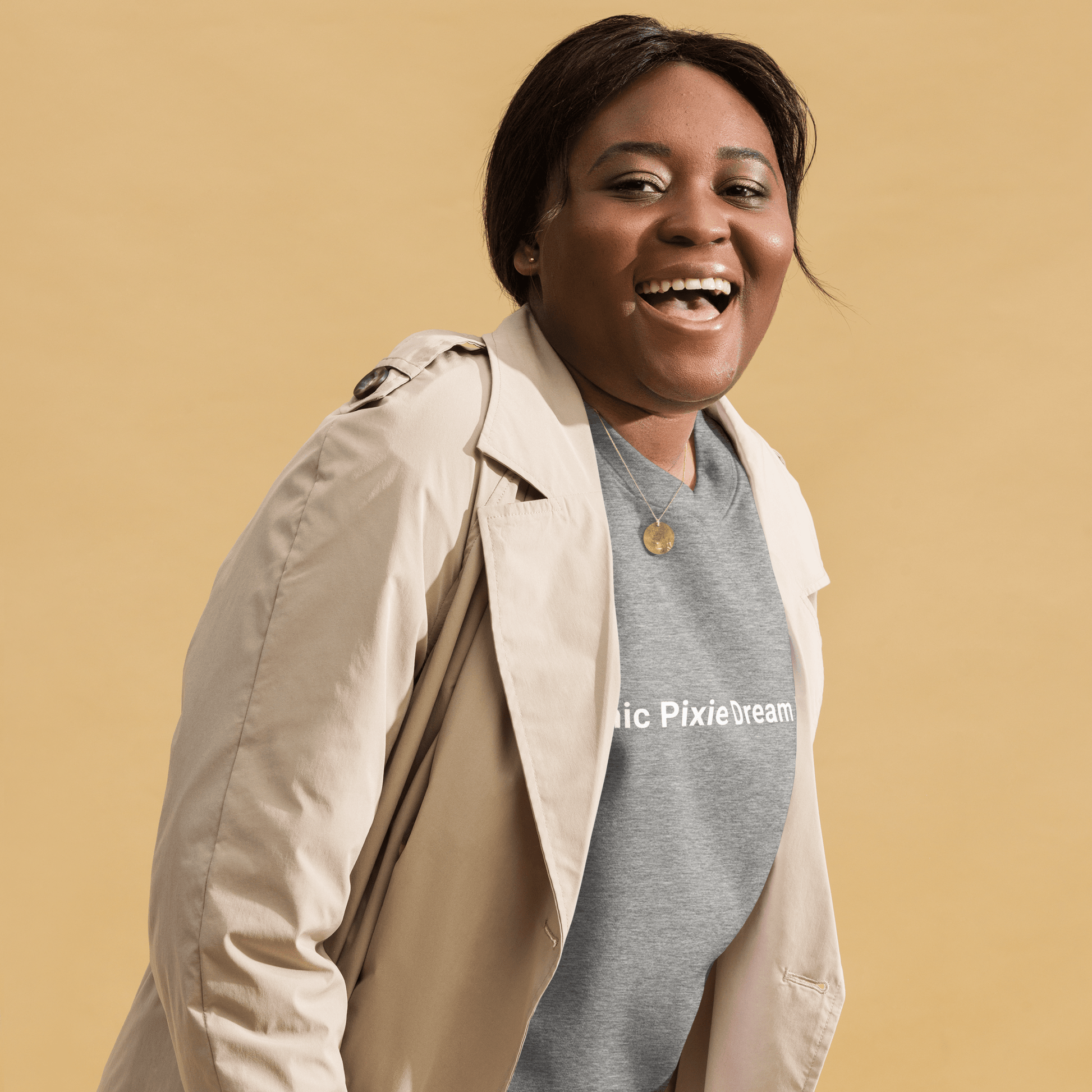 A person is smiling against a tan background, wearing THiNK LiKE A DOG®'s Manic Pixie Dream Dog Navy Sweatshirt – Minimalist & Stylish Tee.