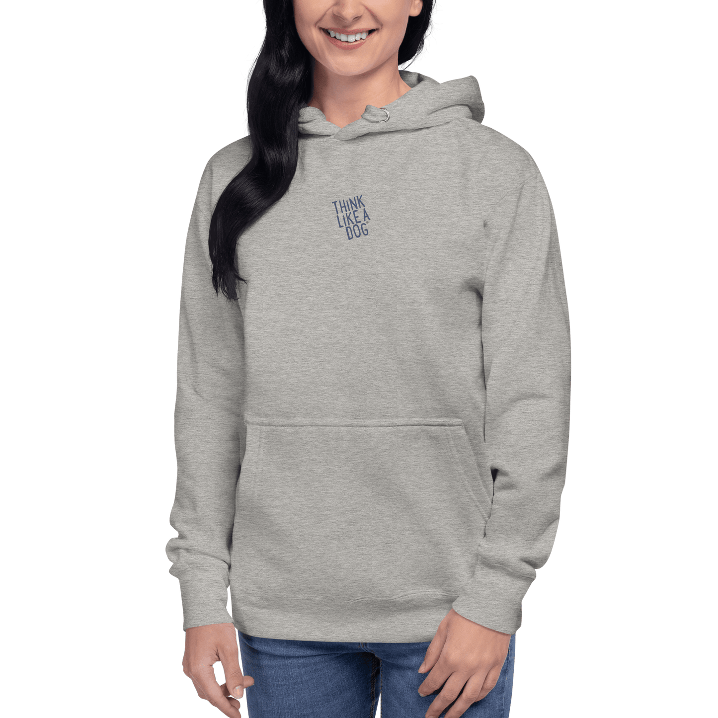 A person wears the THiNK LiKE A DOG® — Carbon Grey Hoodie in light gray, featuring "THINK LIKE A DOG"…