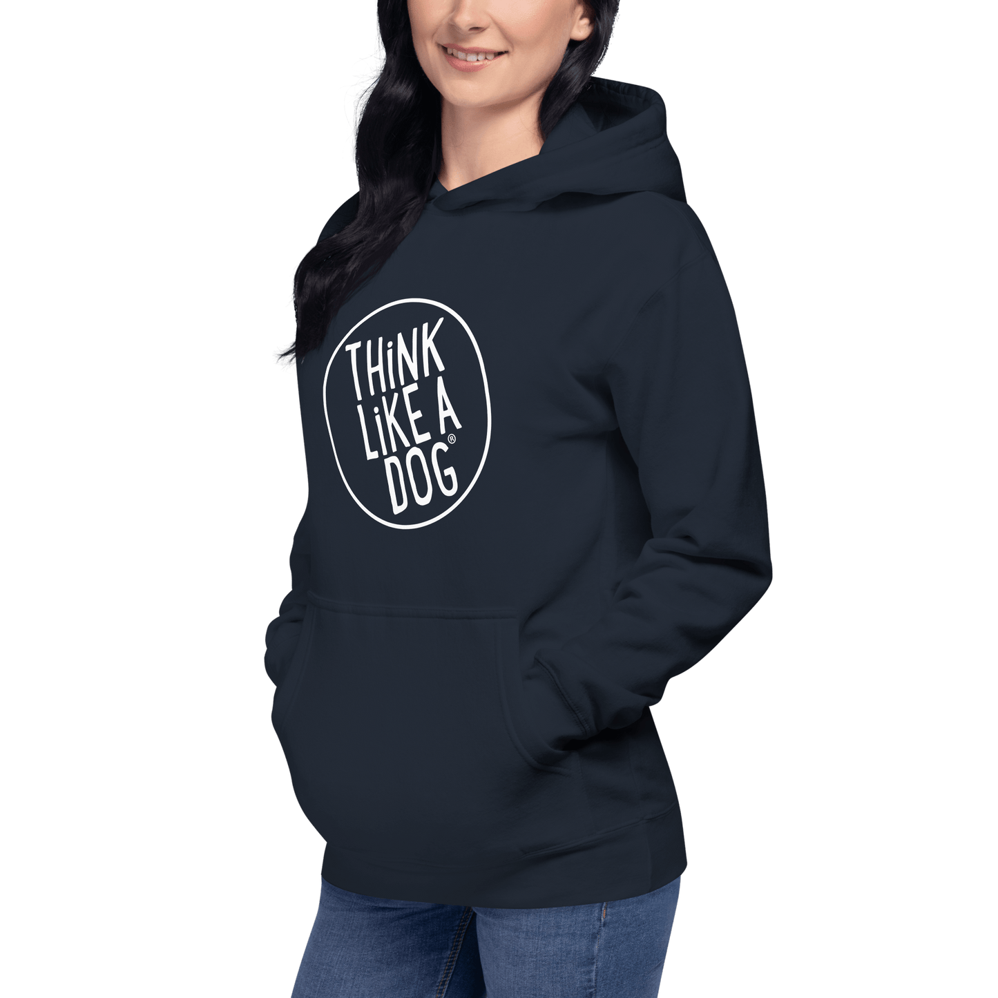 A person stands relaxed in a "THiNK LiKE A DOG® Premium Hoodie," hands in pockets against a neutral backdrop. This cozy sweatshirt is an ideal gift for dog lovers, combining comfort and style with its unique circular design.