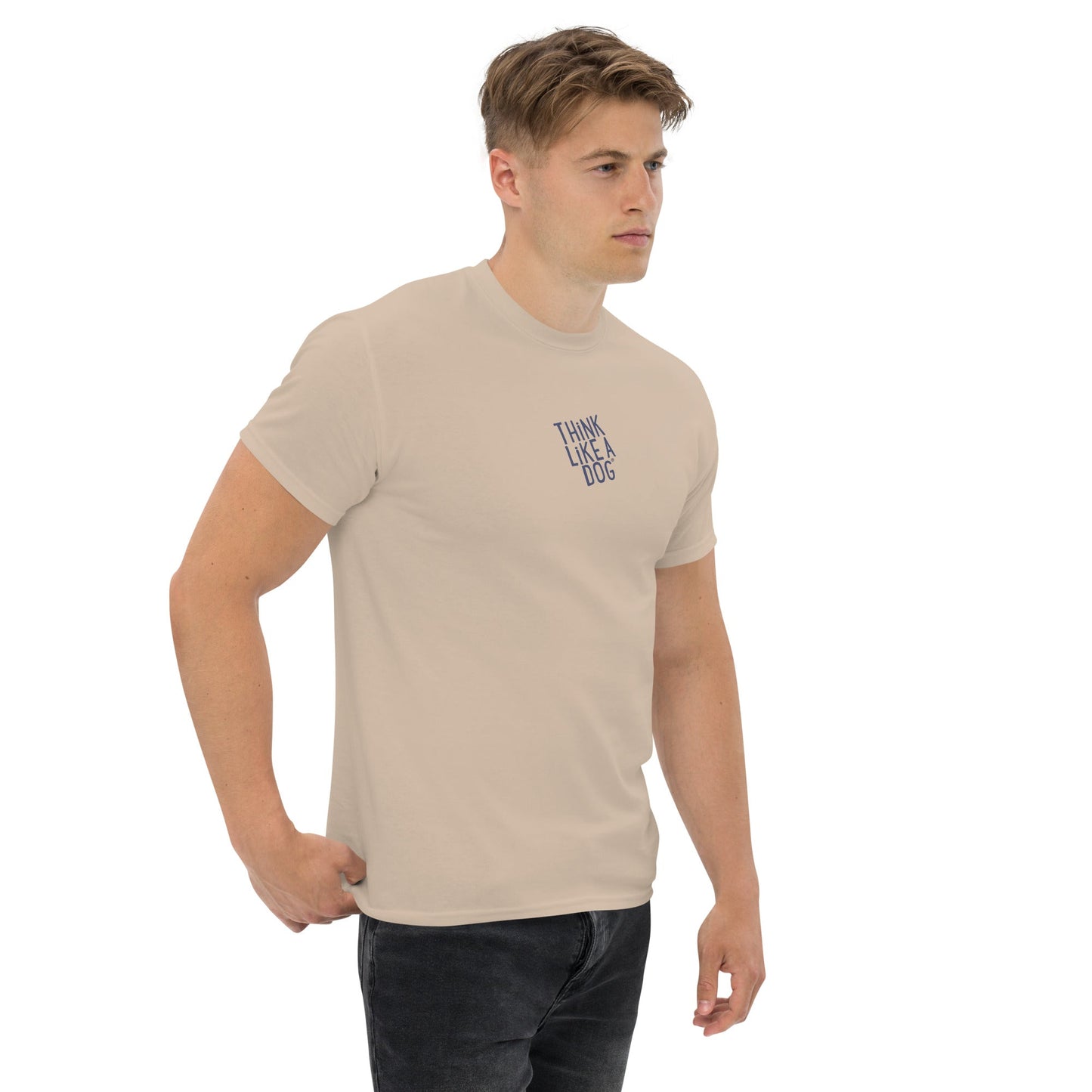 A man wears a THiNK LiKE A DOG® Think Like a Dog T-Shirt with "THINK LIKE A DOG" text and Sport Grey logo, standing against a plain white background.
