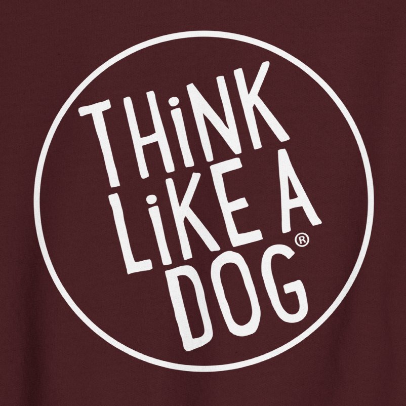 The THiNK LiKE A DOG® Unisex Crewneck Sweatshirt - Large White Logo features a maroon background with a bold white circular logo showcasing the text "THiNK LiKE A DOG," making it an ideal addition to any dog lover's wardrobe. Boost your confidence with this stylish dog-themed apparel.