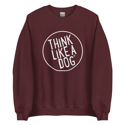 The THiNK LiKE A DOG® Unisex Crewneck Sweatshirt - Large White Logo features the phrase "THINK LIKE A DOG" in bold white text inside a circular outline on the front of a maroon sweatshirt. Perfect for dog lover apparel enthusiasts, this sweatshirt will boost your confidence with its unique dog-themed design.