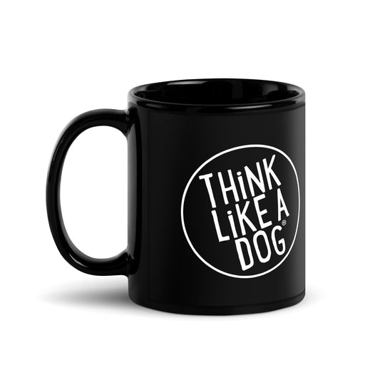 The THiNK LiKE A DOG® black mug features a white circular "Think Like A Dog" design. This stylish cup is perfect for dog lovers who enjoy humor in their daily routine.