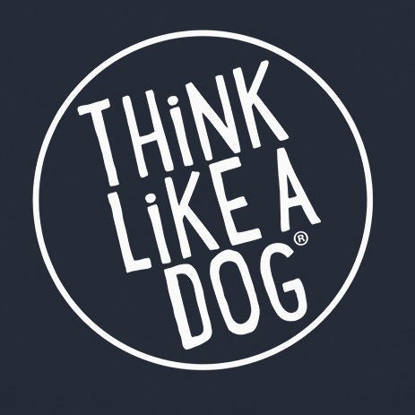 The "THiNK LiKE A DOG" text in white is centered within a white circle against a dark backdrop, making it an ideal design for the THiNK LiKE A DOG® Premium Hoodie, a cozy sweatshirt for dog lovers.