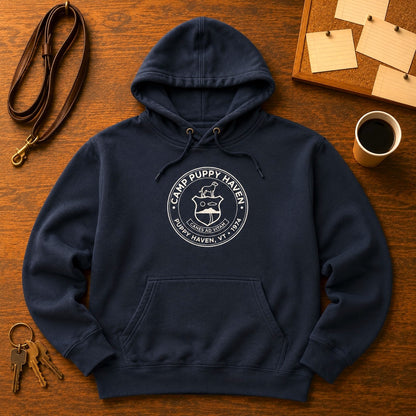 Camp Puppy Haven Badge Hoodie in Navy Blazer laid flat on warm wood with a leather leash, keys, a cup of coffee, and a corkboard of index cards