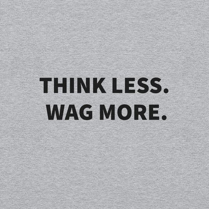 The "Think Less. Wag More." Dog Lover Crewneck Sweatshirt by THiNK LiKE A DOG® features a gray background and bold black text—perfect comfort wear for stress relief and ideal for every true dog lover.