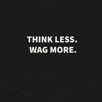 The Think Less. Wag More. Dog Lover Tee by THiNK LiKE A DOG® features white text on a black shirt—perfect for any dog lover’s collection or proud dog parent!.