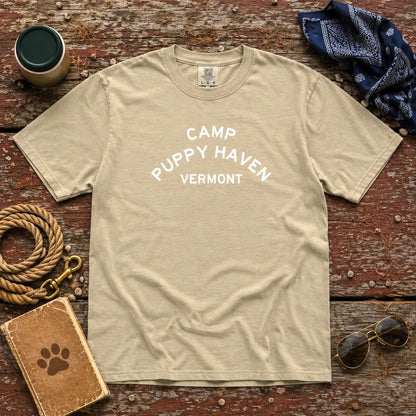 Camp Puppy Haven Vermont Tee in Khaki laid flat on weathered wood with a rope leash, navy bandana, thermos, aviators, and a paw-print notebook