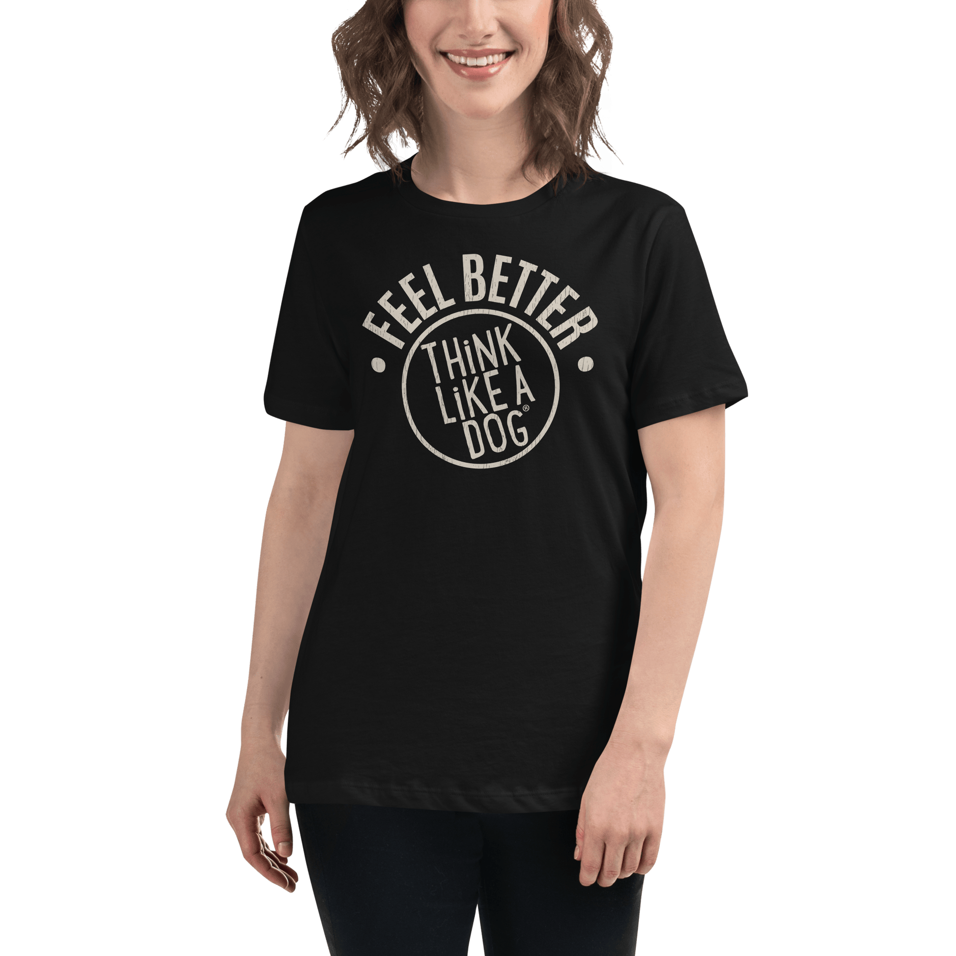 A person wearing a black ultra-soft THiNK LiKE A DOG® Feel Better Women's T-Shirt with "Feel Better, Think Like a Dog" large logo stands against a green backdrop—ideal for dog moms and animal enthusiasts.