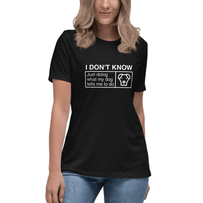 A person wearing a THiNK LiKE A DOG® Funny Dog Shirt—a black women's tee featuring "Just Doing What My Dog Tells Me" and a dog's face. Ideal for dog lovers and enthusiasts of dog mom apparel.