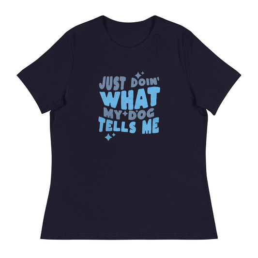 This women's relaxed fit t-shirt from THiNK LiKE A DOG® features blue text on a black tee that reads "Just Doin' What My Dog Tells Me," making it a perfect choice for a funny dog-themed shirt.