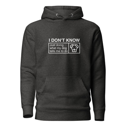 A THiNK LiKE A DOG® dark gray, humorous dog-themed hoodie featuring the text "I Don’t Know, Just Doing What My Dog Tells Me To Do" and a small outline of a dog's head on the front.