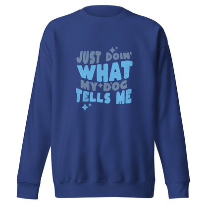 The Quirky Dog Lover Sweatshirt from THiNK LiKE A DOG® features a ‘Just Doing What My Dog Tells Me’ design in light blue and white font on a blue backdrop, making it the perfect choice for any dog lover.