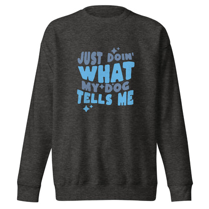 A dark gray, dog-themed sweatshirt by THiNK LiKE A DOG® featuring the phrase "Just Doing What My Dog Tells Me" printed in large blue letters on the front.