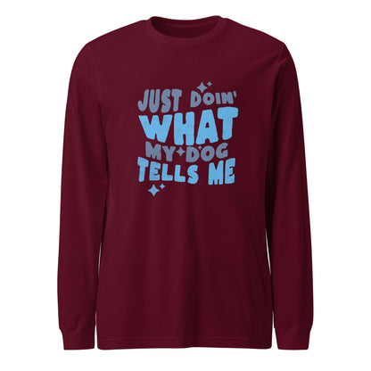 The THiNK LiKE A DOG® Quirky Dog-Themed Long Sleeve Shirt in maroon features the bold blue text "Just Doin' What My Dog Tells Me" along with small star accents, making it a perfect and comfortable choice for any dog lover.