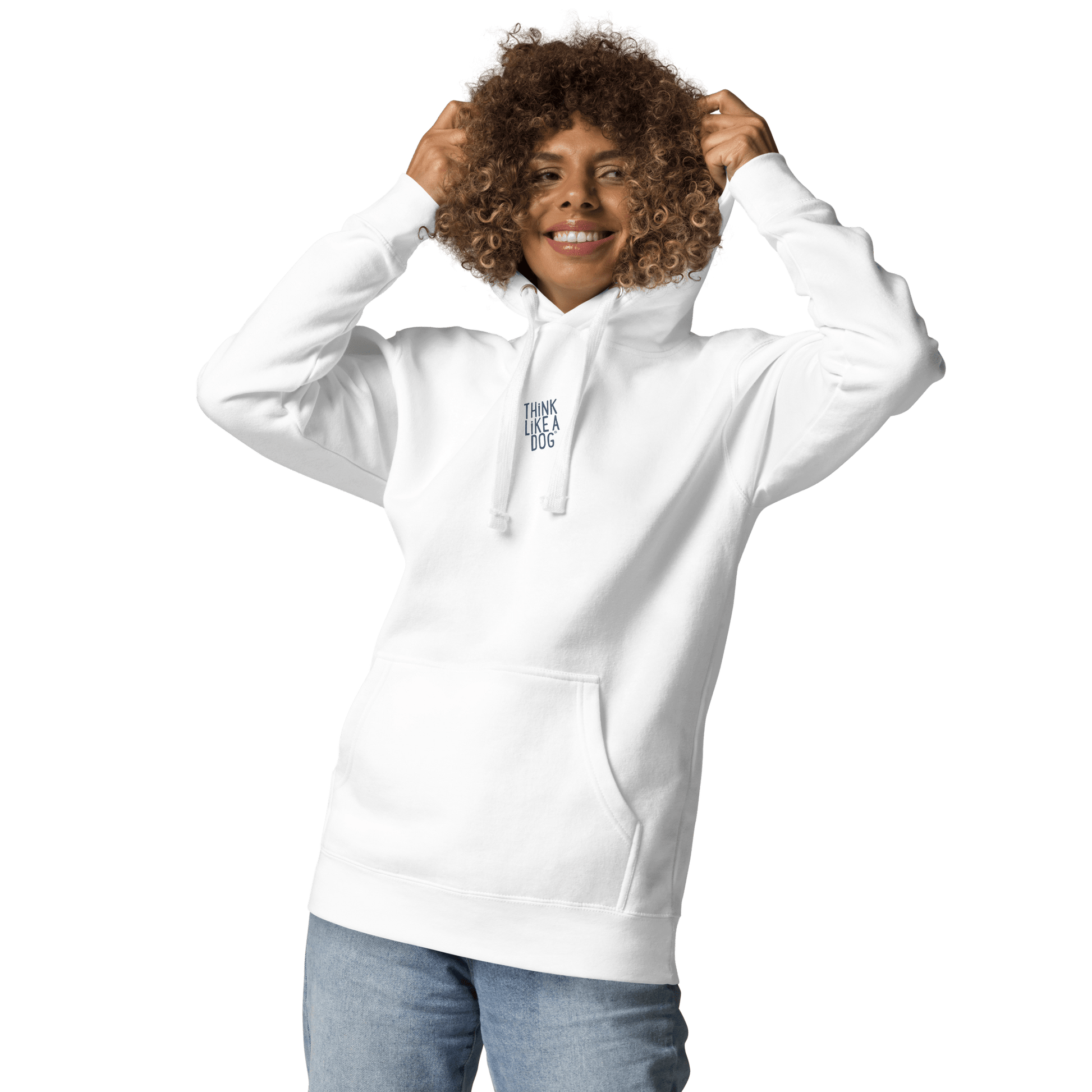 A smiling person in a THiNK LiKE A DOG® Think Like a Dog Hoodie — Everyday Comfort, featuring "Think Like a Dog" text on the chest, holds the hood while standing against a plain light background.