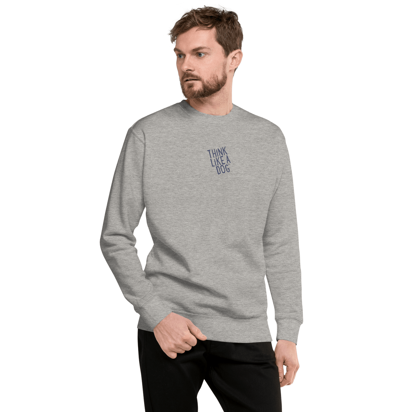A man wears the THiNK LiKE A DOG® "Think Like a Dog Sweatshirt — Everyday Comfort" in light gray, featuring cozy cotton fleece and chest text, paired with black pants, standing against a white background.