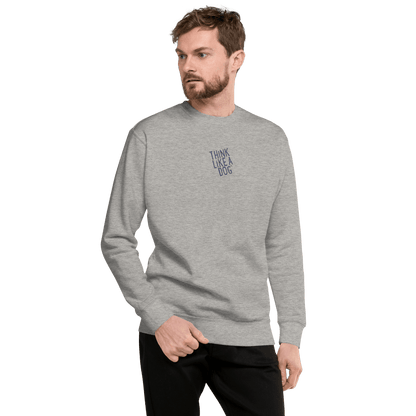 A man wears the THiNK LiKE A DOG® "Think Like a Dog Sweatshirt — Everyday Comfort" in light gray, featuring cozy cotton fleece and chest text, paired with black pants, standing against a white background.