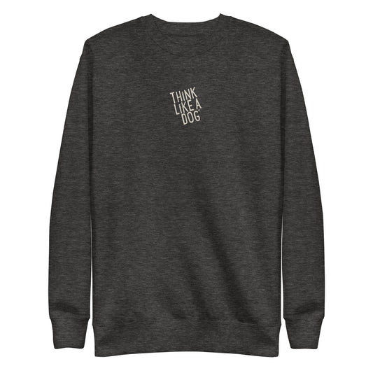 The THiNK LiKE A DOG® Think Like a Dog Sweatshirt — Everyday Comfort is a dark gray unisex fleece crewneck with "THINK LIKE A DOG" in small white letters on the upper chest, offering cozy style for dog lovers.