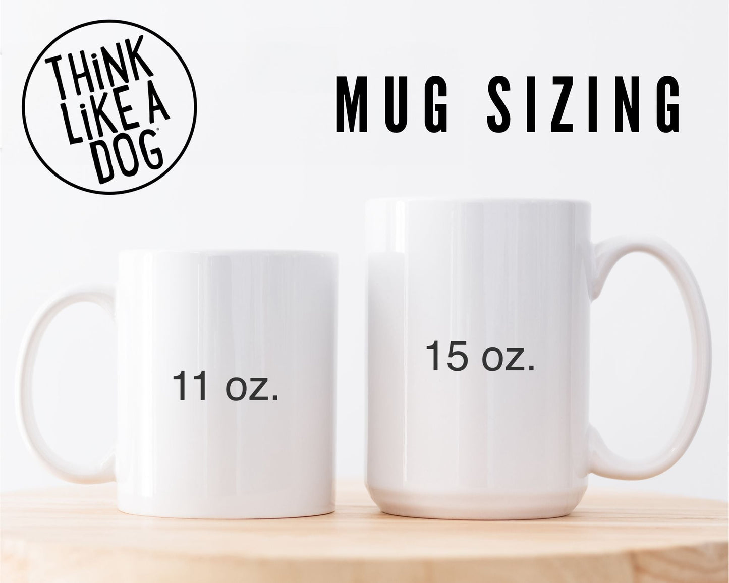 Two White Glossy Mug Live Your Life. Not The Other Dog's with handles on a wooden surface, labeled "11 oz." and "15 oz." respectively, with text above reading "think like a dog - mug sizing.
