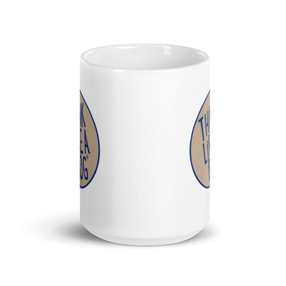 A white coffee mug with a THINK LiKE A DOG® Blue & Tan Colorway logo on it for dog lovers.