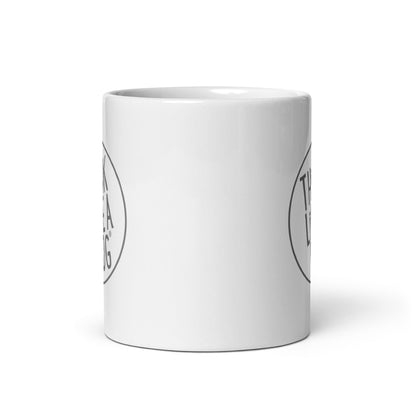 A White Glossy Mug Grey THiNK LiKE A DOG® Logo with "Think Like a Dog" text and graphics for dog lovers on its surface, isolated on a white background.