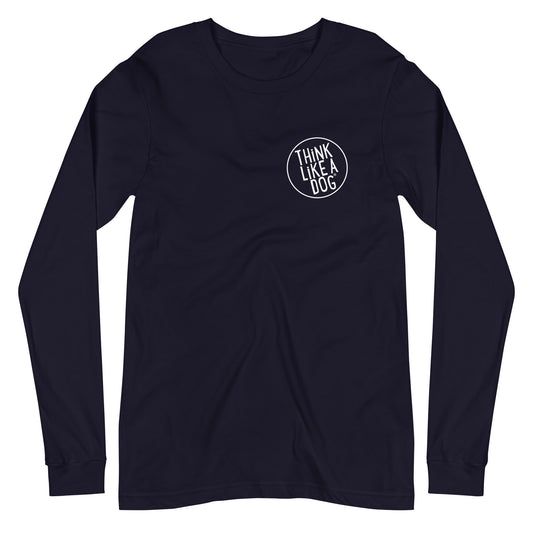 Introducing the Unisex Long Sleeve Tee with Small White "Think Like A Dog" Logo from THiNK LiKE A DOG®. This navy blue, long-sleeved shirt is designed for dog lovers and features a white circular design on the left chest that reads "THINK LIKE A DOG." Perfect for adding some comfortable, dog-themed apparel to your wardrobe.